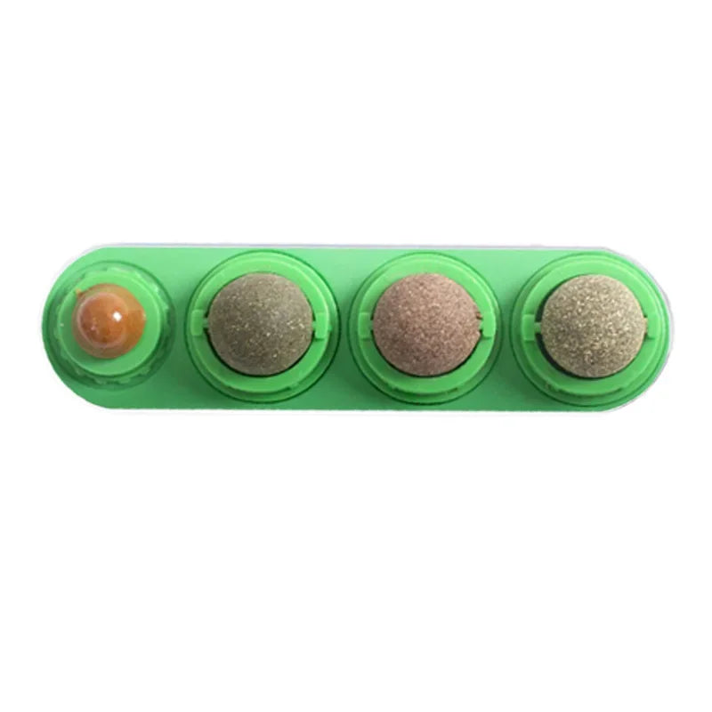 A green plastic tray holding four rotating catnip balls for a toy.