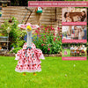 A pink goose clothing item with a long neck for outdoor decoration displayed on a green lawn.