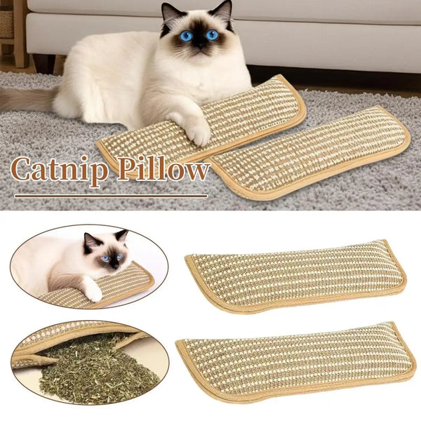 A white cat is relaxing on a gray surface next to several rectangular catnip pillows.