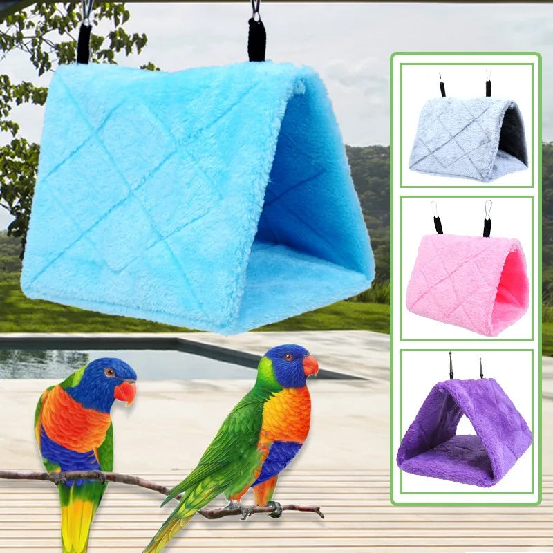 A cozy plush hanging bird hammock bed in various colors, including blue, pink, and purple, shown with a parrot.