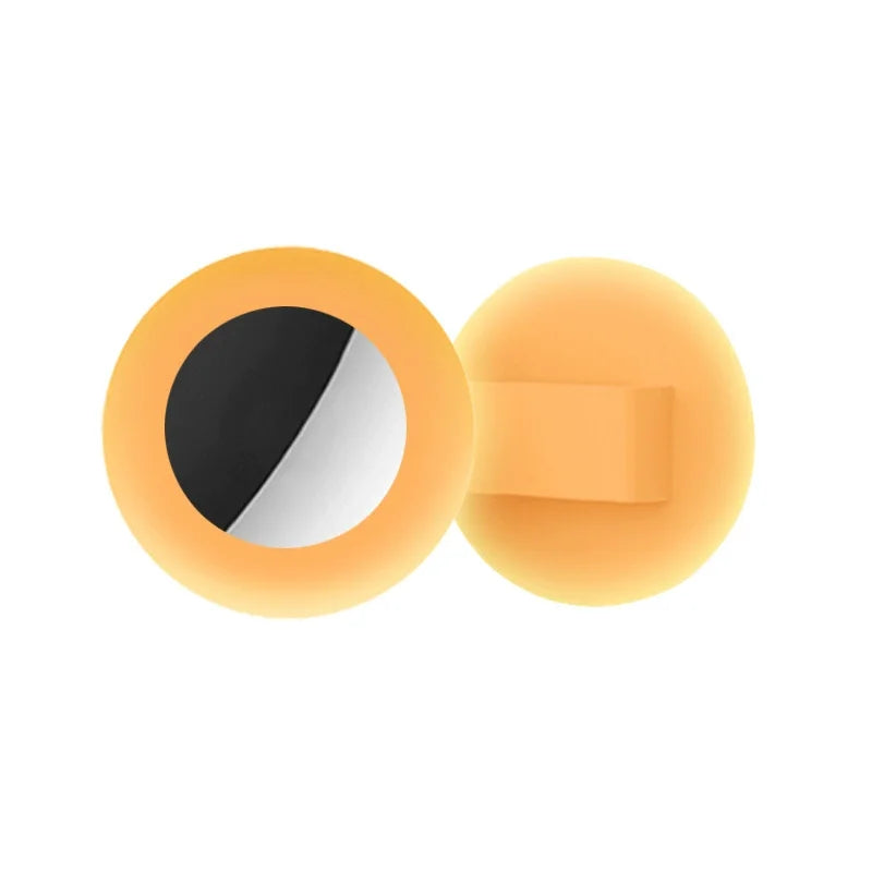 A silicone airtag collar holder for cats and small dogs, shown in a warm orange color.