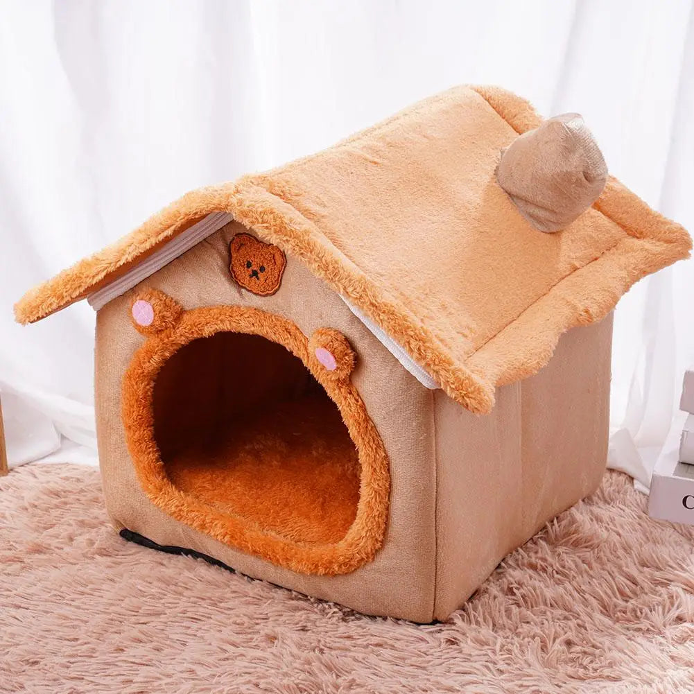 A cozy plush pet bed cave made of tan fabric with a removable, fluffy cushion and an angled roof.