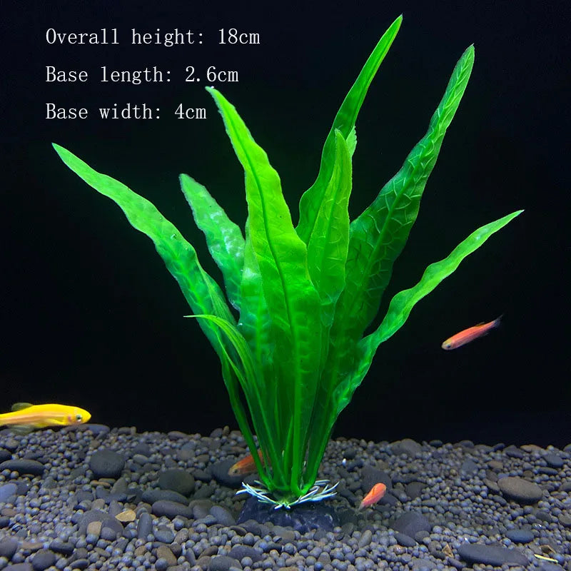 A vibrant green artificial aquarium plant with large leaves is rooted in dark gravel.