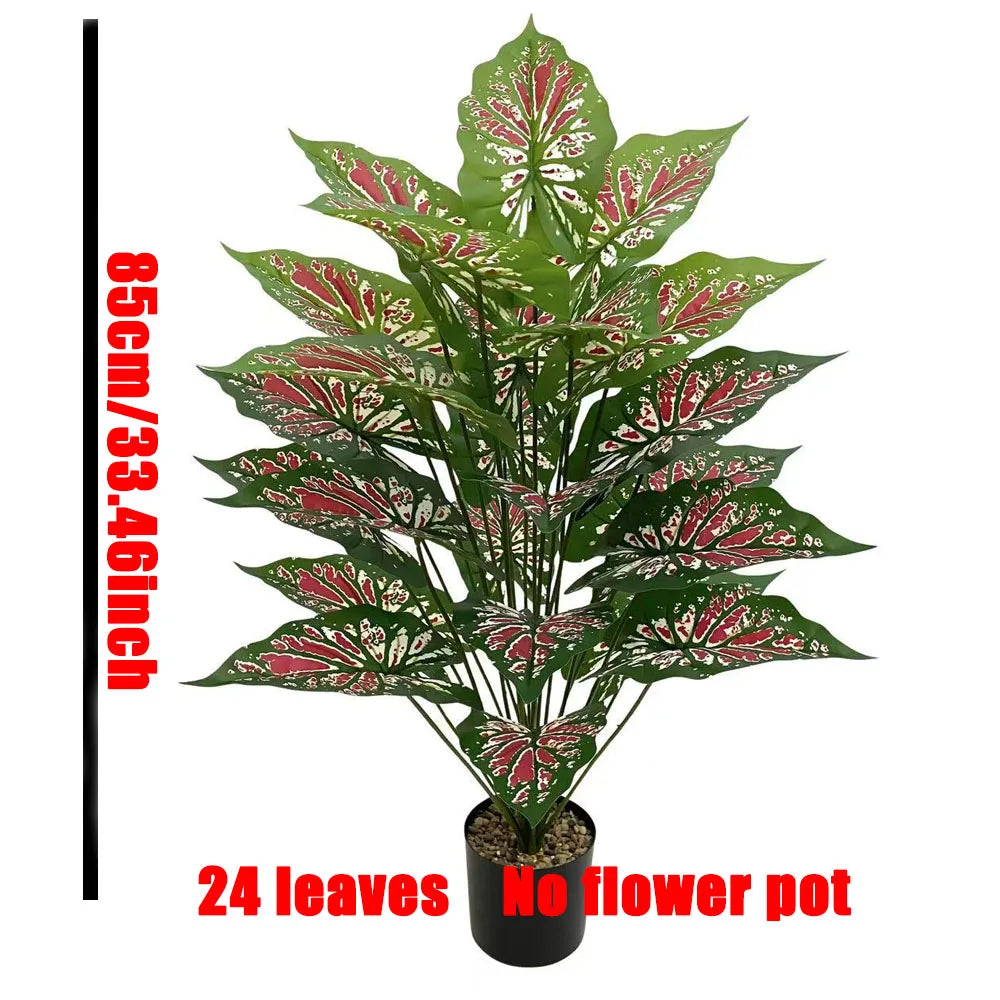 A bouquet of 24 artificial Monstera leaves with green and red variegation displayed in a black pot.