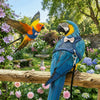 A blue and yellow macaw perched on a wooden railing amidst lush pink and purple flowers.