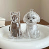 Clear silicone pet hair storage keychain shaped like a dog sitting on a white plate.