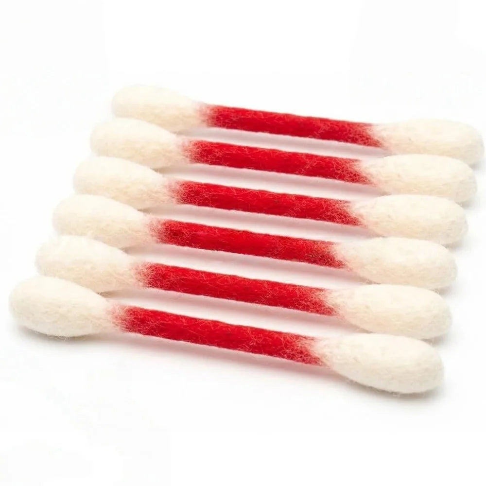 A set of oversized cotton swabs with white tips and red shafts used as cat toys for play and dental care