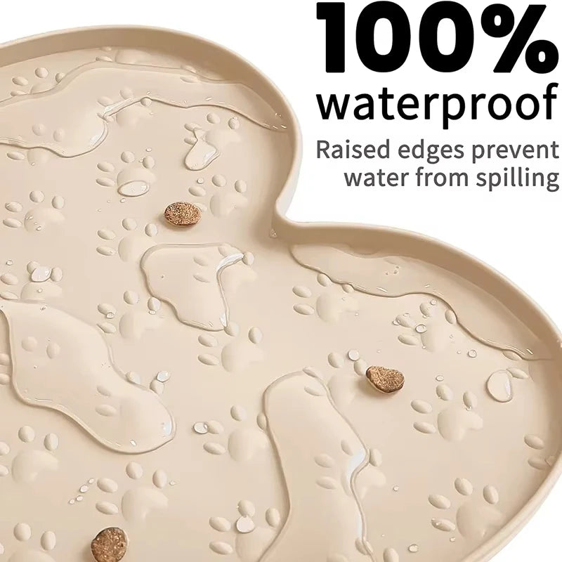 A beige silicone pet feeding mat showing water droplets on its surface with raised edges.