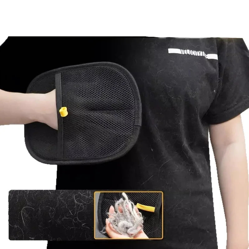A hand is shown using a black double-sided pet grooming glove to remove hair from a pet.