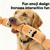 A golden retriever holds a sausage-shaped plush squeaky dog toy in its mouth.