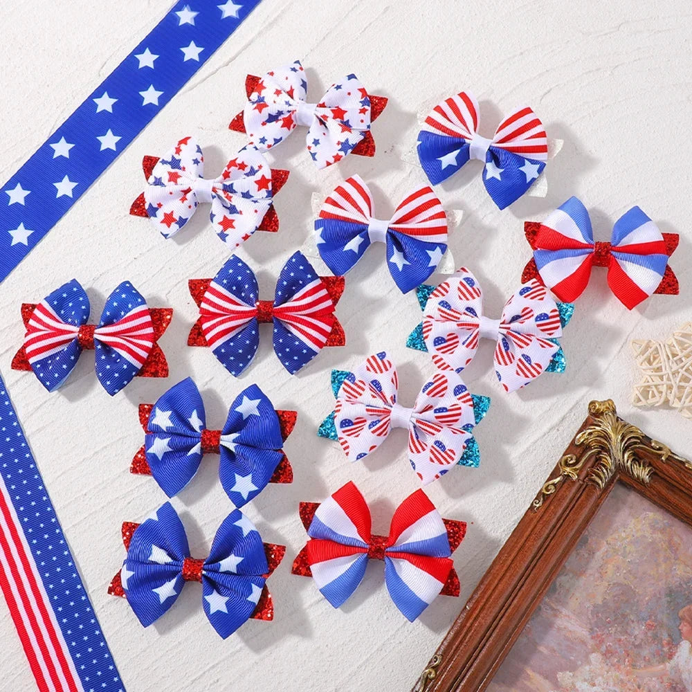 A collection of red, white, and blue star patterned ribbon hair bows with clips arranged on a white surface.
