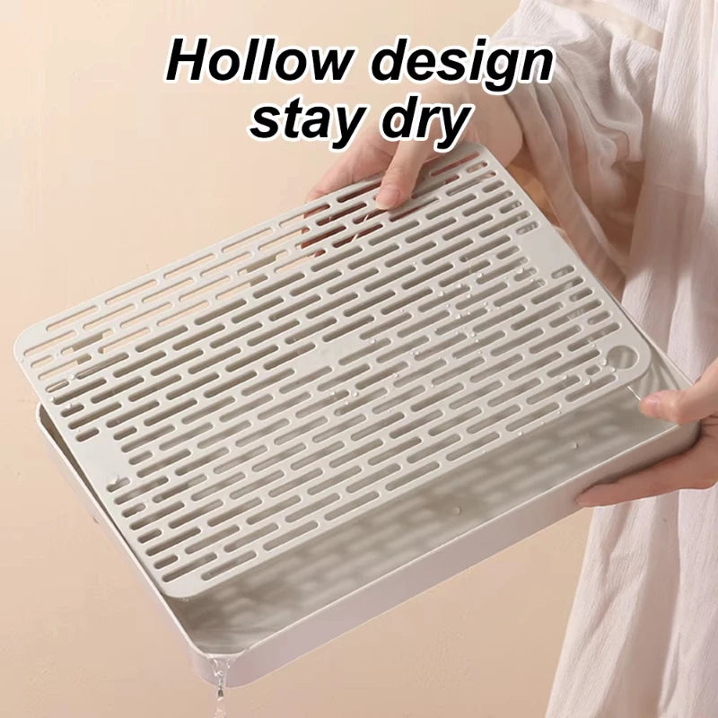 A white pet litter box with a hollow design is shown being held, demonstrating its stay dry feature.