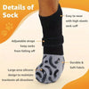 A close-up of a black anti-slip cotton dog sock with an elastic cuff and silicone grip design.