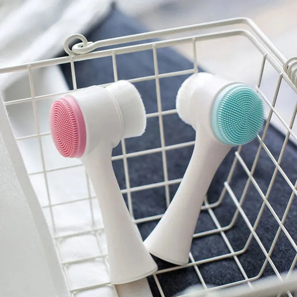 A white dual-sided silicone pet paw cleaner and massage brush with pink and teal bristles inside a wire mesh basket.