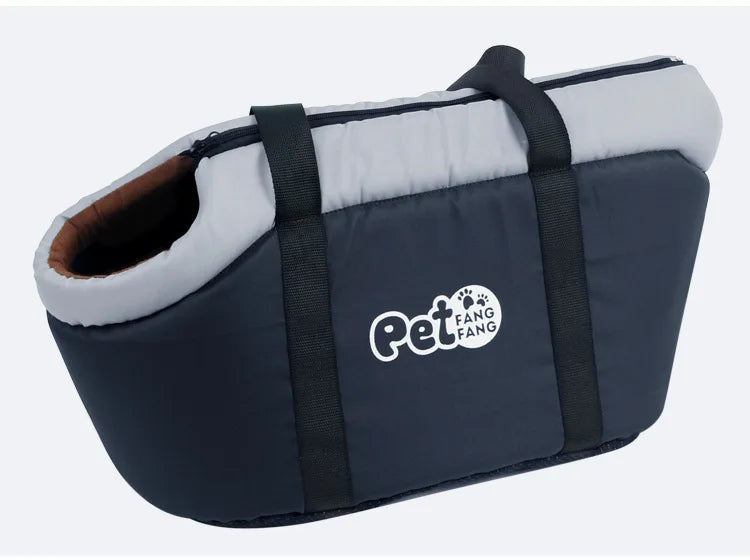 A navy blue portable foldable pet carrier bag with a light gray lining and a black strap.