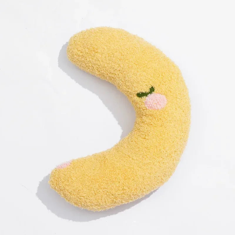 A yellow U-shaped cat sleeping pillow with a pink face detail, shown against a white background.