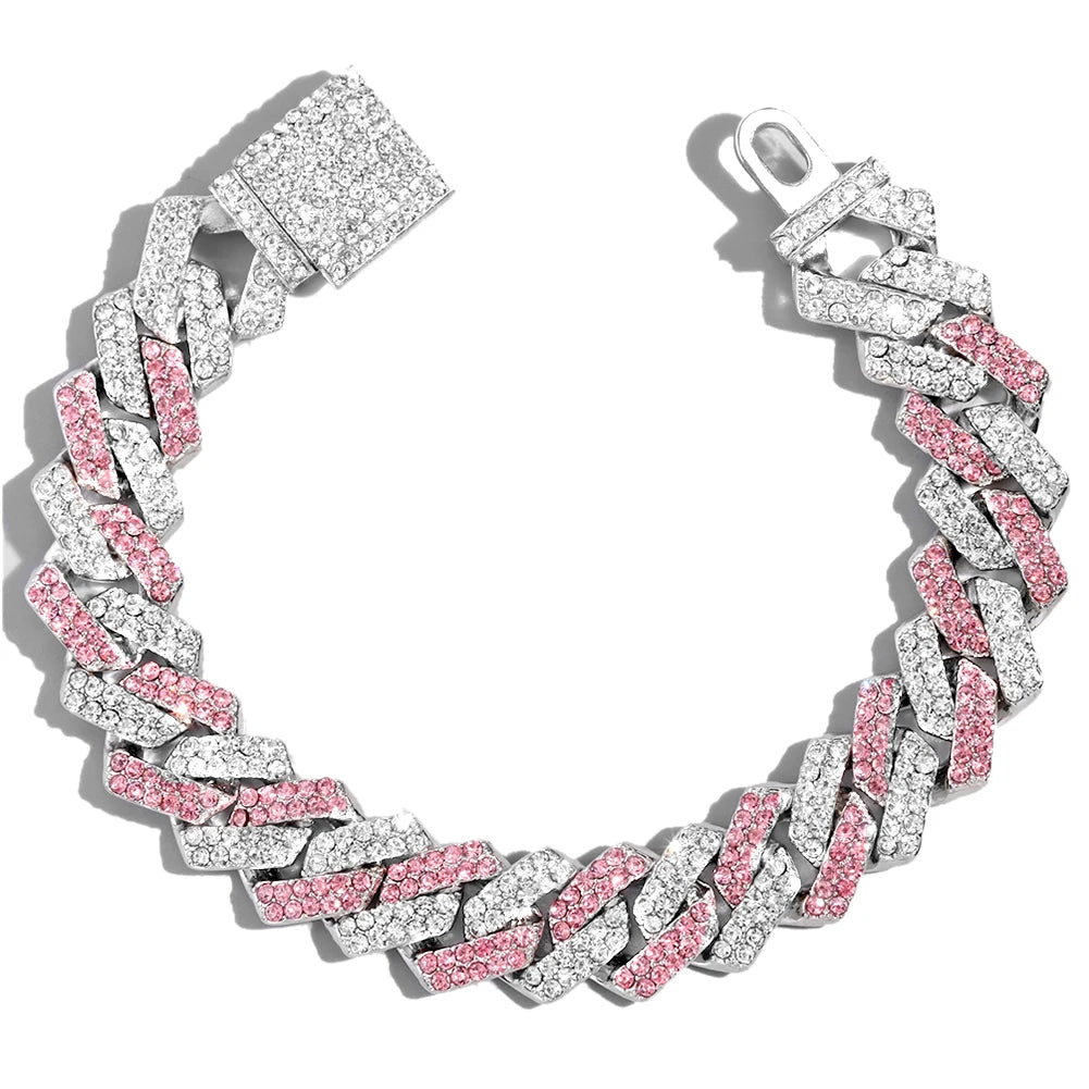 A silver iced-out Cuban link bracelet featuring pink and clear rhinestones.