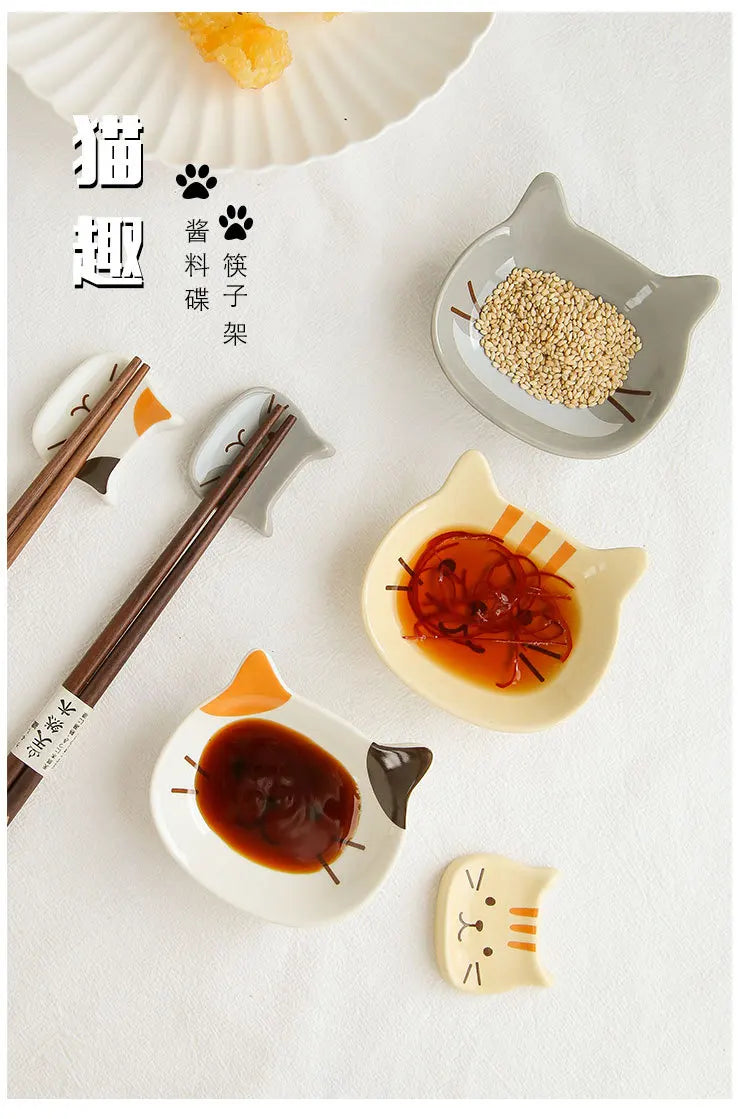Japanese style cat-shaped ceramic sauce dish with accompanying chopsticks and sesame seeds