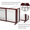 A dark brown wooden pet gate with black bars and a decorative metal piece, showing its construction and features.