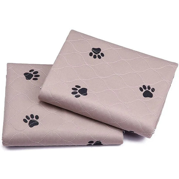 A stack of beige washable reusable dog urine pads featuring a subtle paw print pattern.