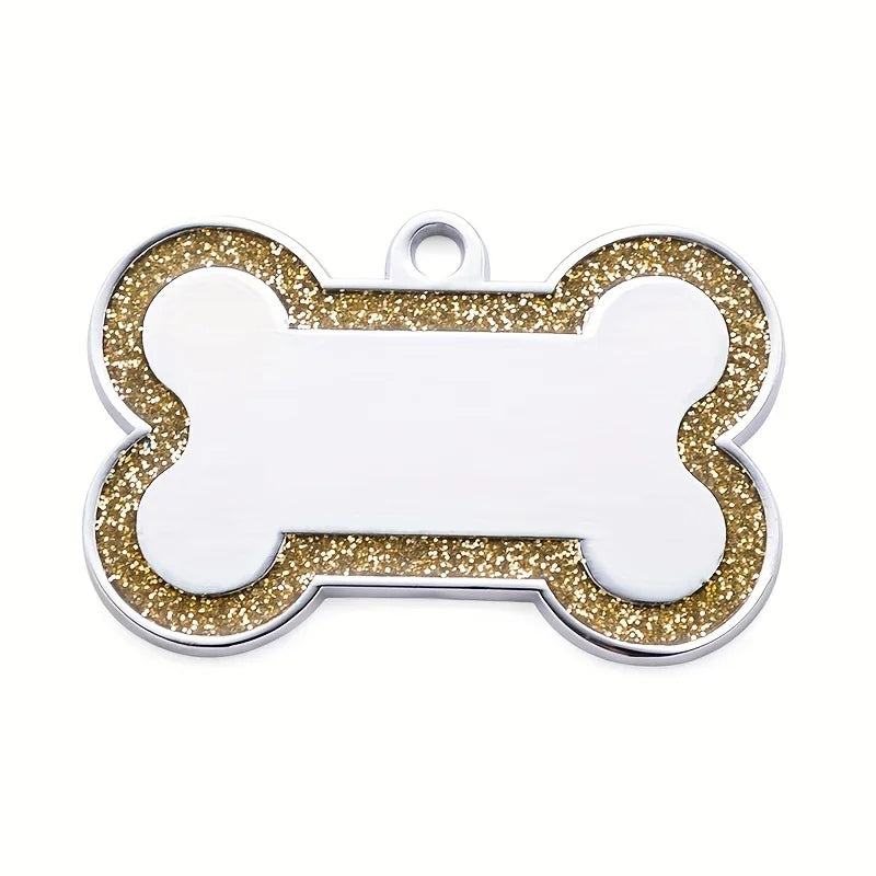A silver pet ID tag shaped like a bone with gold glitter accents.