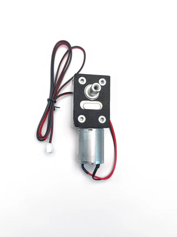A black electronic module with a silver cylindrical component and attached wires.