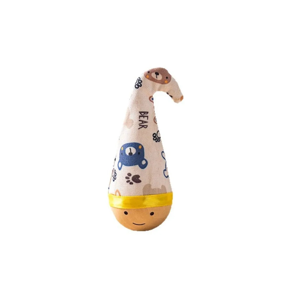 A soft, light yellow fabric toy shaped like a bear head with a feather on top for indoor play.
