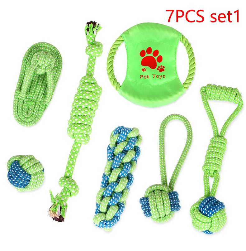A set of seven green cotton rope dog toys including a chew toy, a pull toy, and a knotted toy.