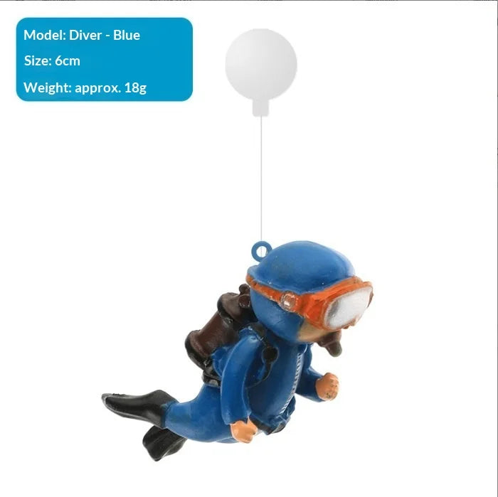 A blue diver ornament with a clear visor is suspended by a thin string.