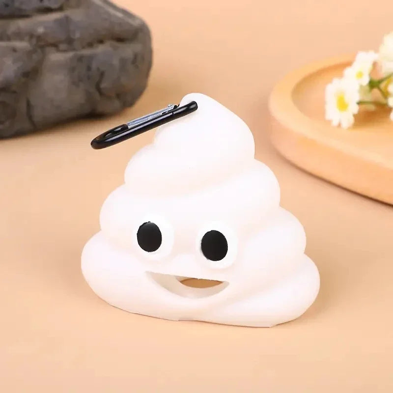 A white silicone dispenser shaped like a cloud with a black stick, resting on a light brown surface.