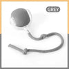 A grey interactive pet ball for dogs and cats with a cord attached.