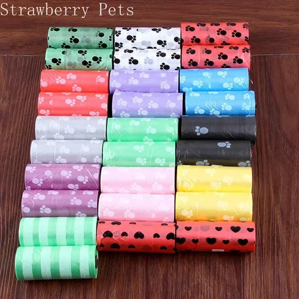 A stack of ten rolls of colorful, patterned dog poop bags in various shades of pink, green, and orange.