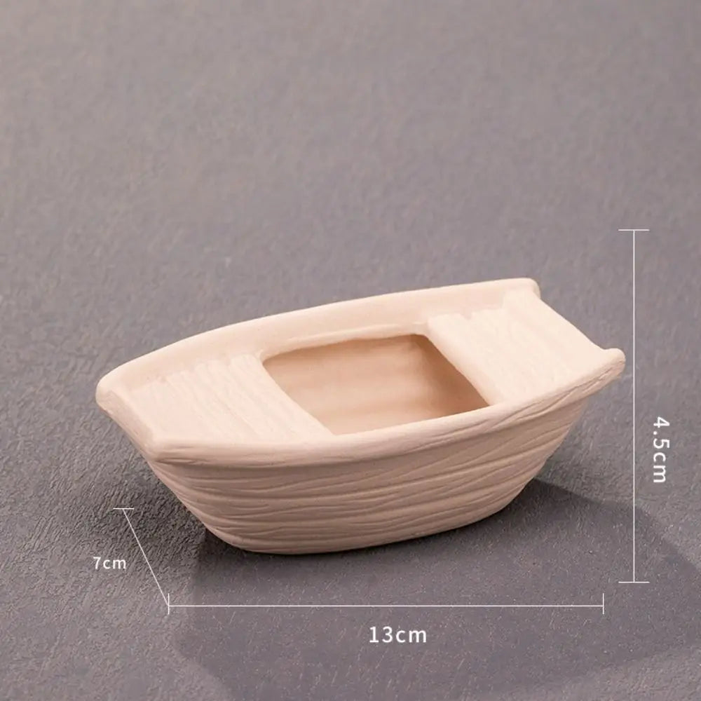 A light beige ceramic aquarium shrimp hideaway cave with a rectangular opening and textured sides.