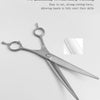 Silver professional pet grooming shears with sharp cutting teeth shown against a white background.