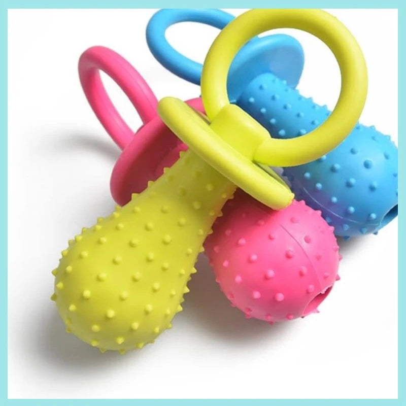 A collection of colorful rubber pacifier chew toys in pink, yellow, and blue with various shapes and rings.