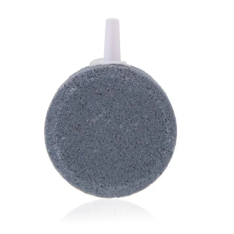 A grey air stone disc with a white nozzle for aquarium aeration.