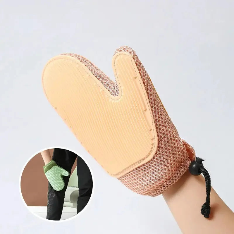 A light peach double-sided pet grooming glove for cats and dogs shown on a paw.