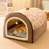 A beige pet bed with a rounded, arched entrance and a patterned fabric for dogs or cats is shown on a light-colored carpet.