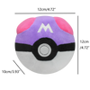 A purple and pink plush toy shaped like a Poké Ball with a white 'M' emblem on the top.