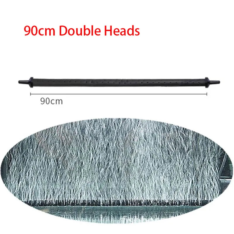 Pompe à air d'aquarium noire et flexible avec une surface texturée, à côté d'une échelle de mesure.
