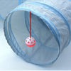 A light blue foldable cat tunnel is shown with a red string hanging down through the opening.