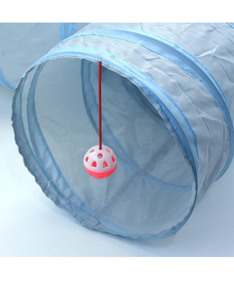 A light blue foldable cat tunnel is shown with a red string hanging down through the opening.