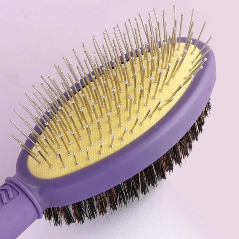 A purple double-sided pet grooming brush with yellow bristles and black rubber backing.