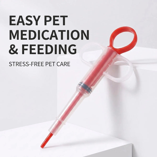 Kit de biberón con jeringa para medicación de mascotas de color rojo sobre una superficie blanca.