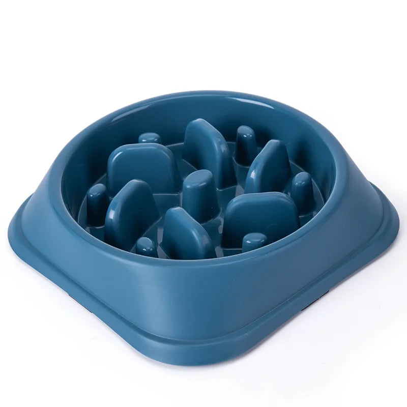 A blue non-slip slow feeder bowl for dogs with various puzzle shapes inside.