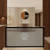 A black portable folding pet safety gate with a breathable mesh is shown in a modern interior setting.