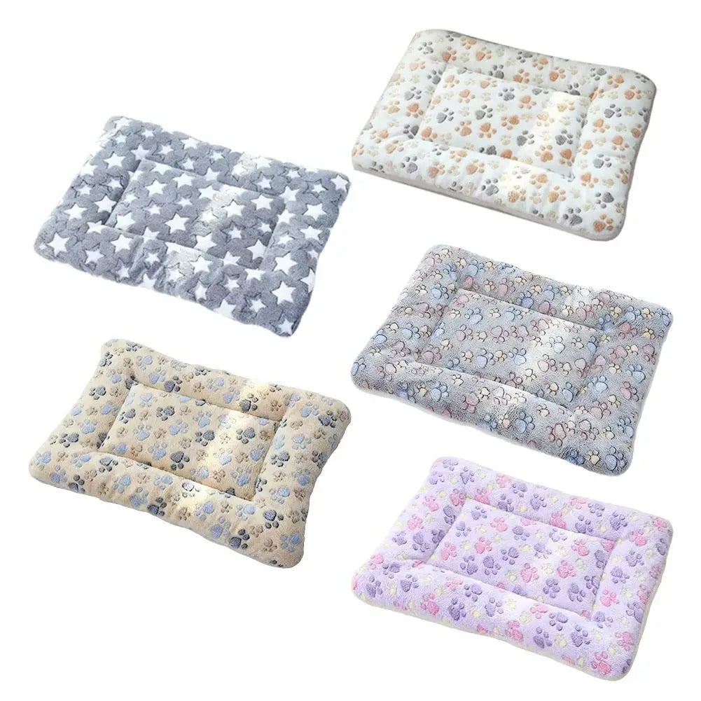 A collection of plush double-sided pet blankets featuring various floral and star patterns in gray, beige, and purple.
