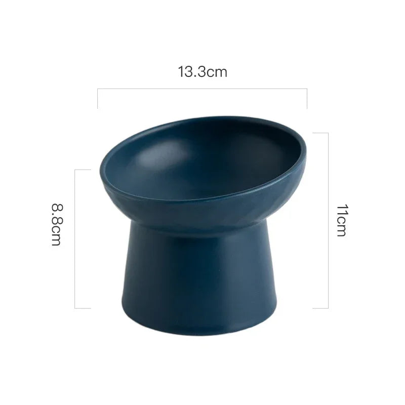 A dark blue elevated ceramic food bowl with a wide rim and a sturdy base.