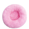 A round, pink plush pet bed designed for dogs and cats.