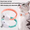 A gray cat is interacting with a white and orange self-entertainment laser cat toy worn on its neck.